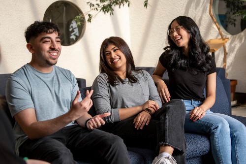 Three people together laughing