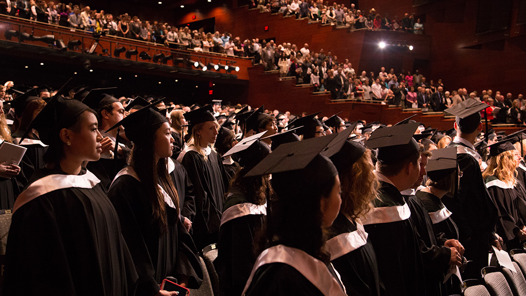 Group of grads standing for graduation ceremony 