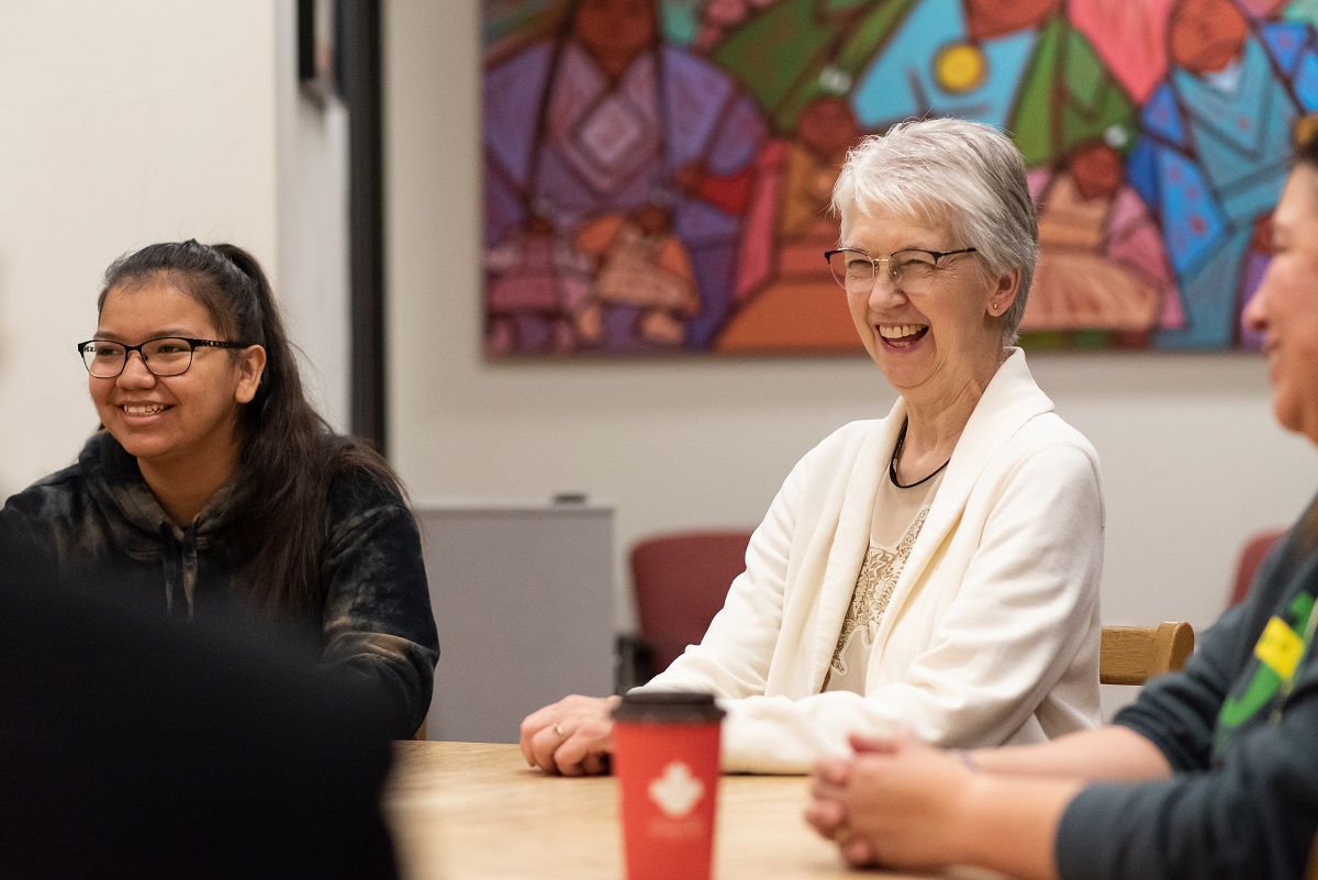 Susan Jensen (right) visits campus and meets with faculty of arts students including Rogan Alexis (left).