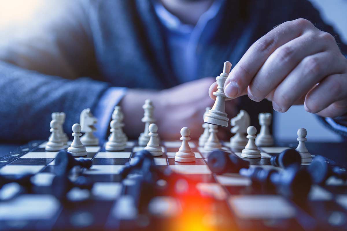 Close up of hands playing chess against and unseen opponent