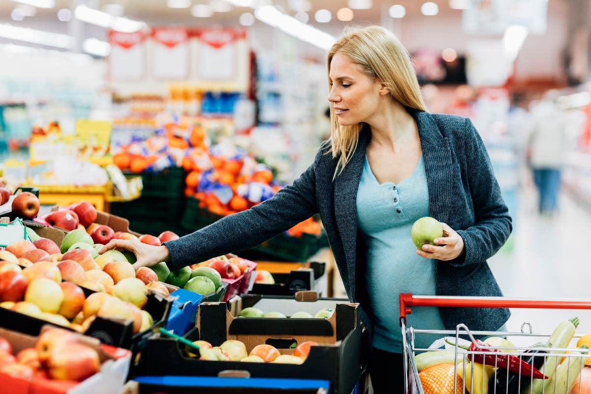 A woman shops for fruit in a supermarket.