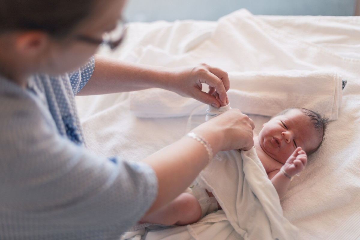 A parent pictured with a baby. New study examines urinary metabolome of healthy newborns to aid in diagnosis for sick infants.