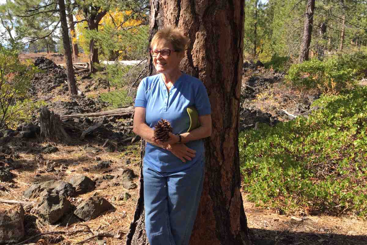 Alumna and Faculty of Science supporter Lorna Stickel, pictured leaning against a tree outside.