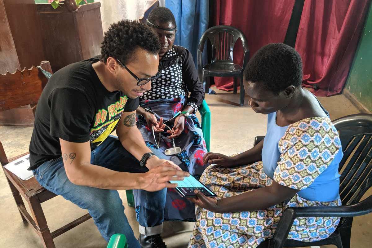 hD student Daniel Robles is pictured here training a local volunteer on using wearable EEG technology.